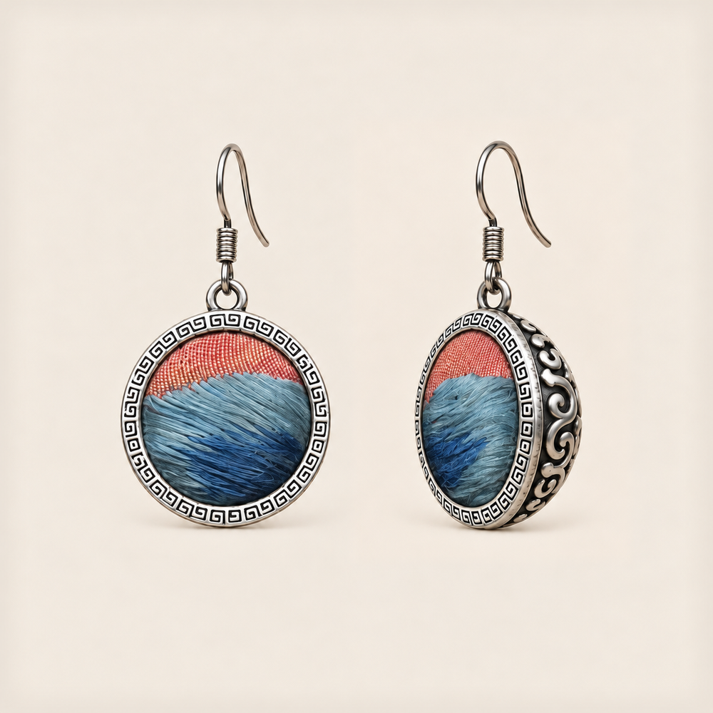 Coral Rhapsody round earrings with layered blue embroidery, coral-colored upper sections, geometric rims and domed scrollwork backs.