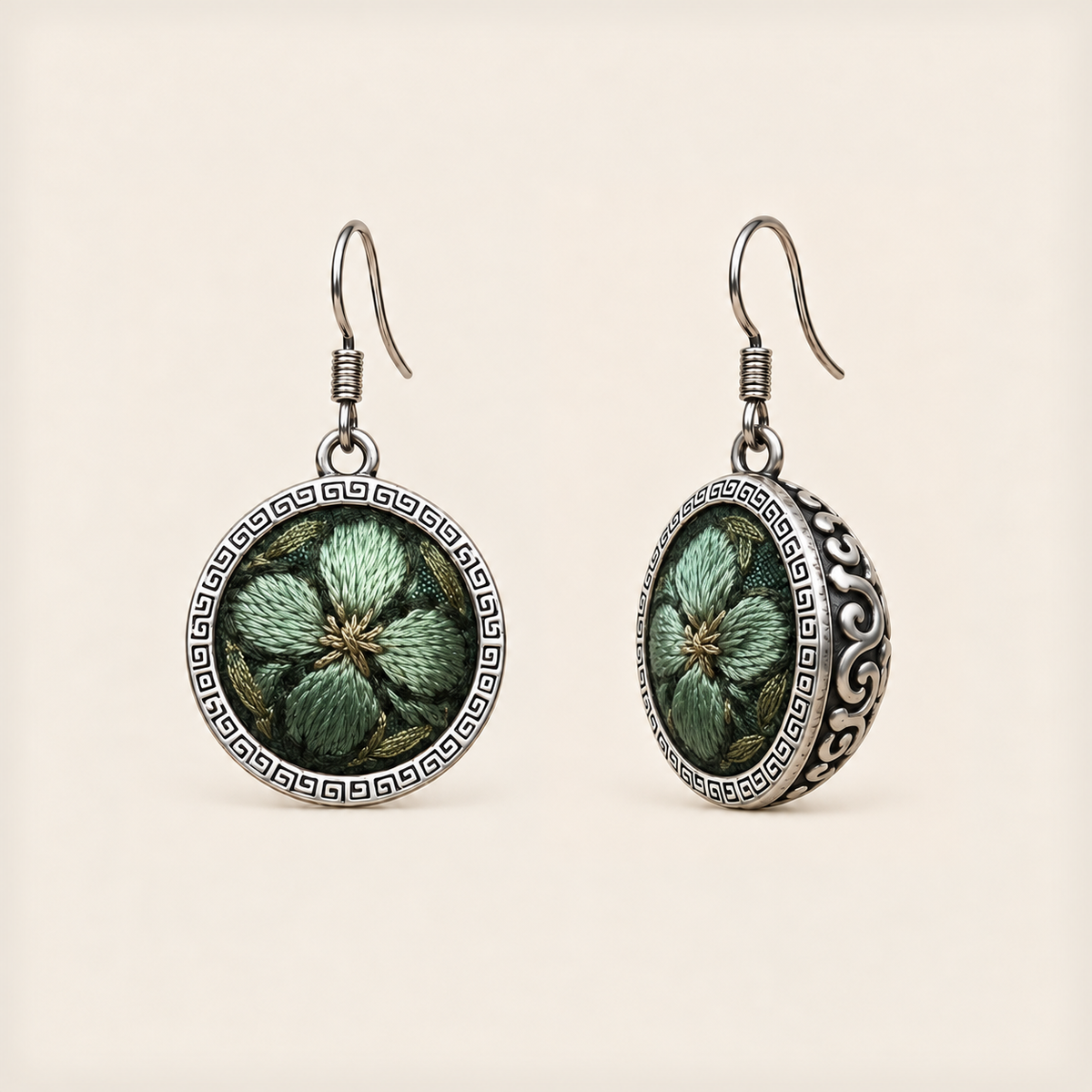 Verdant Bloom round earrings with green embroidered petals, gold-colored details, geometric rims and domed scrollwork backs.