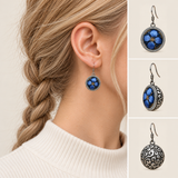 Sapphire Reverie earring worn with its blue floral front facing outward, beside front, 45-degree and domed reverse views.
