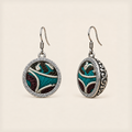 Jade Arabesque round earrings with pale raised curves, teal and burgundy embroidery, geometric rims and domed scrollwork backs.
