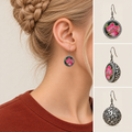 Rosy Aubade earring worn with its pink floral front facing outward, beside front, 45-degree and domed reverse views.