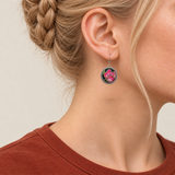 Rosy Aubade earring worn with pink and pale embroidered petals and gold-colored outlines facing outward.