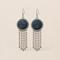 Indigo Canticle Batik earrings with pale radial and curling motifs on indigo textile, round patterned rims and five chains ending in teardrops on each earring.