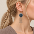 Indigo Canticle earring worn with its pale patterned indigo batik front and five dangling chains ending in teardrops.