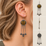Golden Benediction earring worn with its yellow embroidered front and inscribed pendant facing outward, beside front, side and floral reverse views.