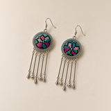 Pastel Refrain pair laid flat, showing different arrangements of pink, teal and pale counted-thread geometric motifs on the two dark round fronts.