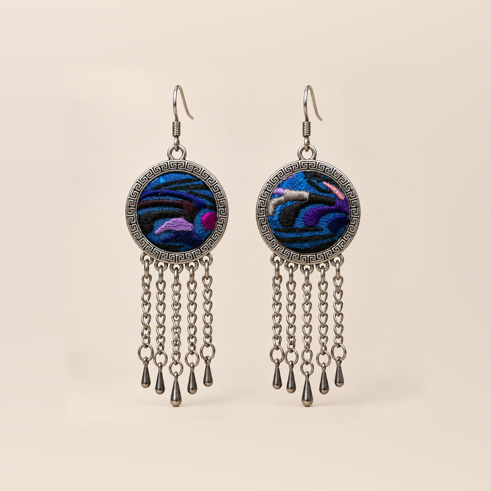 Violet Undertow earrings with blue, violet and dark curved embroidered bands in round patterned frames, each with five linked tassels and teardrop ends.