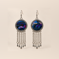 Violet Undertow earrings with blue, violet and dark curved embroidered bands in round patterned frames, each with five linked tassels and teardrop ends.