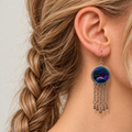 Model wearing Violet Undertow with the blue and violet split-thread embroidered front facing outward above five linked tassels.