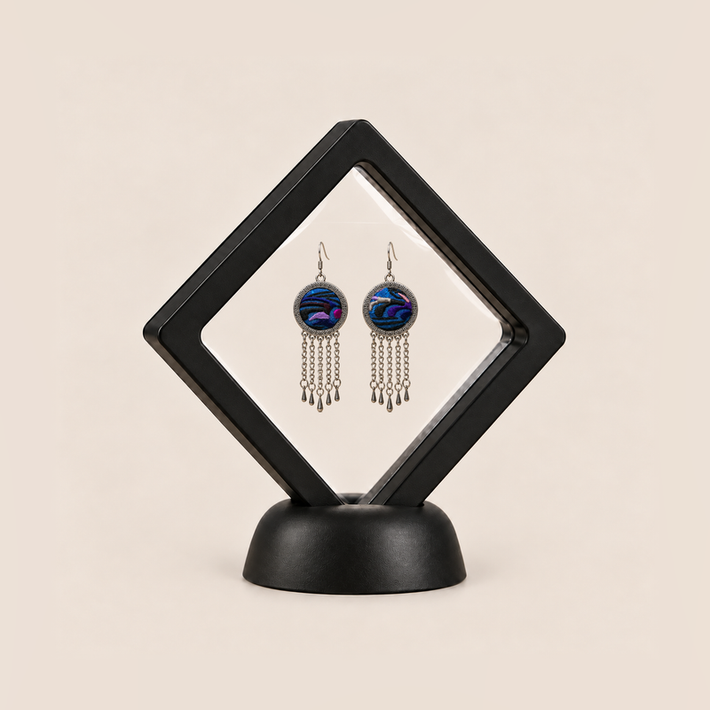 Violet Undertow pair displayed in a black square clear-membrane frame on a black stand, with both blue-violet embroidered fronts facing forward.