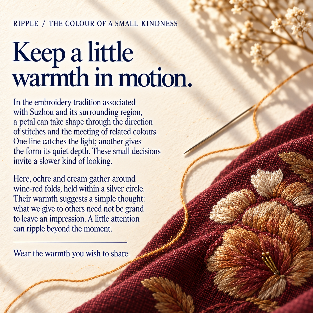 Suzhou embroidery culture card titled Keep a little warmth in motion., beside wine-red cloth with ochre and cream embroidered petals, a needle and golden-colored thread.
