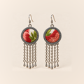 Coral Reverie earrings with coral-red and pink embroidered petals and green leaves on ivory-colored round fronts, each with five oval-link chains and teardrop ends.