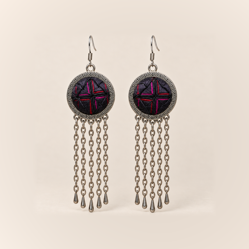Crimson Confluence earrings with dark purple-black layered fabric and red and magenta folded edges in round frames, each with five long oval-link chains and teardrop ends.