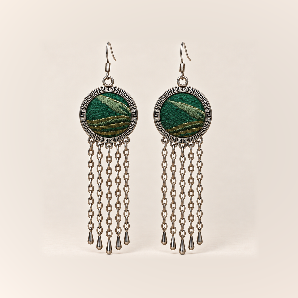 Verdant Concord earrings with emerald Song Brocade fronts, pale diagonal motifs, gold-olive curved bands and five long oval-link chains with teardrops.