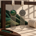 Verdant Concord front and floral reverse hanging from pale woven loops on a wooden frame, with green textile and a thread-filled shuttle below.