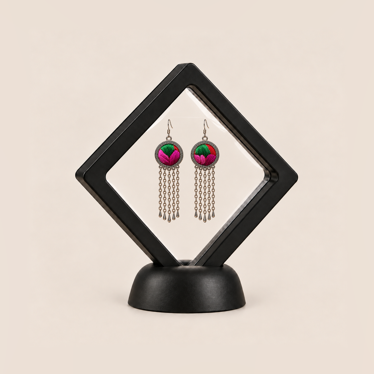 Rose Chorus earrings displayed in a tilted black square membrane frame on a round black base.