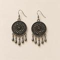 Pair of Azure Harmony floral metal reverses on cream cloth, each with a smooth outer rim and five short teardrop pendants.