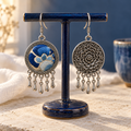 Azure Harmony embroidered front and floral reverse hanging from a dark blue T-bar stand, each with five short teardrop pendants.