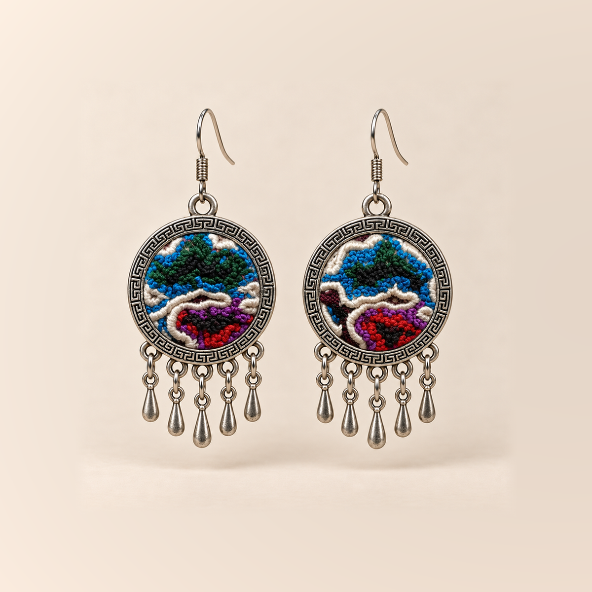 Chromatic Accord Knotted Embroidery earrings with blue-green upper forms, red and purple below, pale curved outlines and five short teardrops.