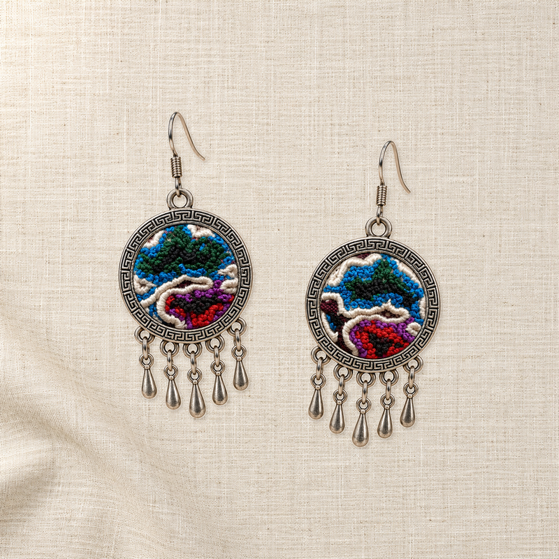 Both Chromatic Accord embroidered fronts face upward on plain cream woven cloth, with distinct colored knotted patterns and five short drops each.